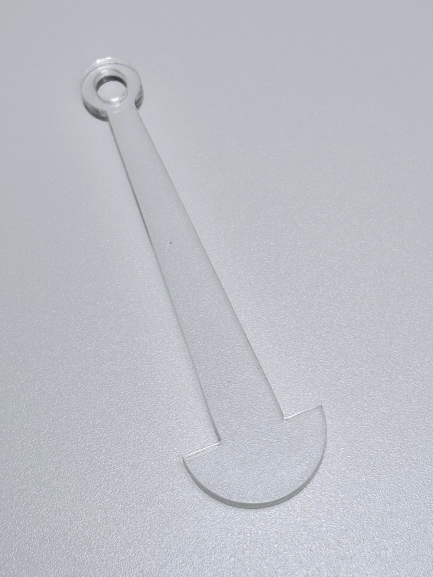 Clear plastic tool on a gray background