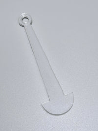 Clear plastic tool on a gray background