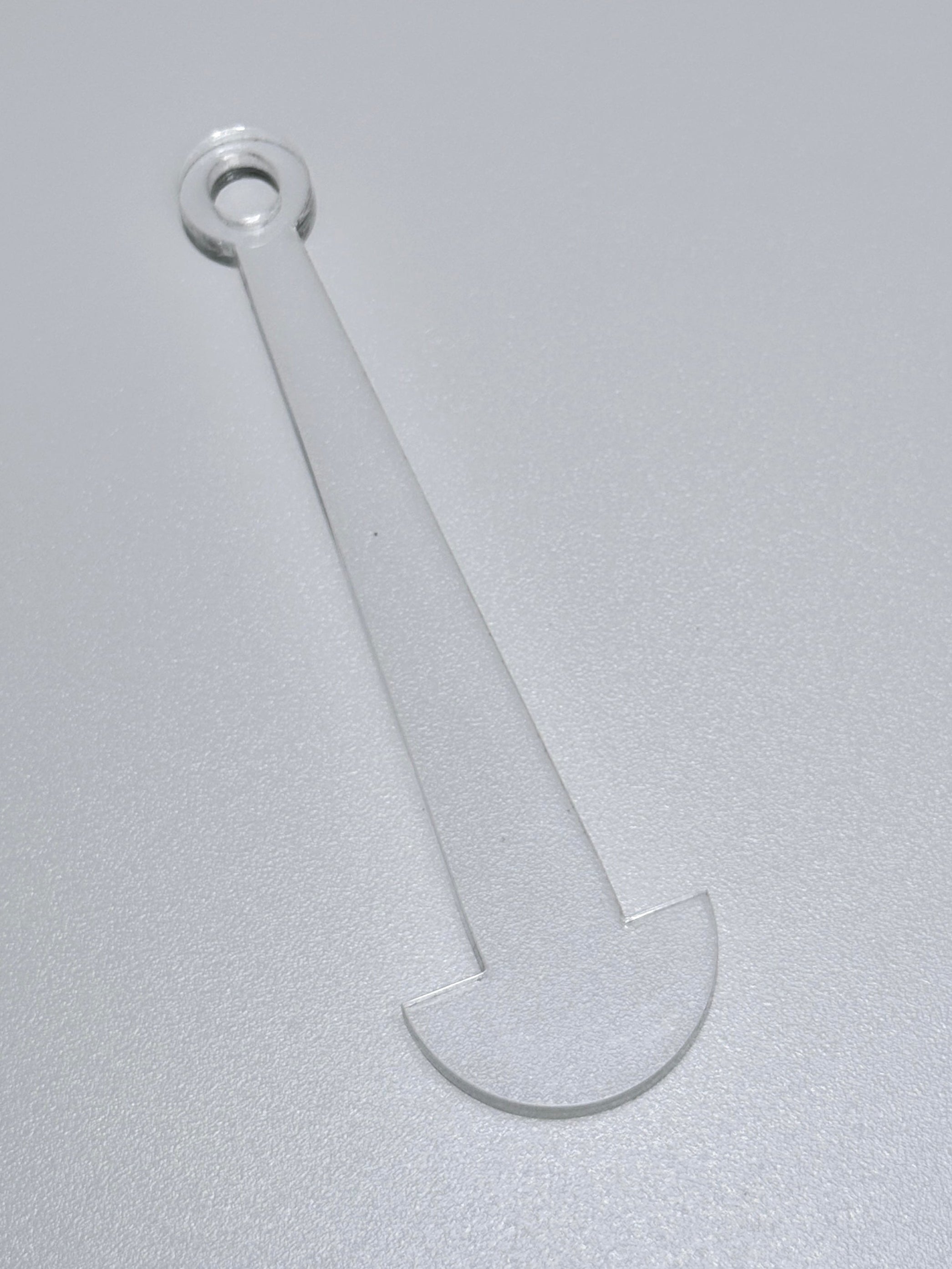 Clear plastic tool on a gray background