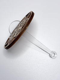 wooden yarn holder with a clear acrylic stick on a white background