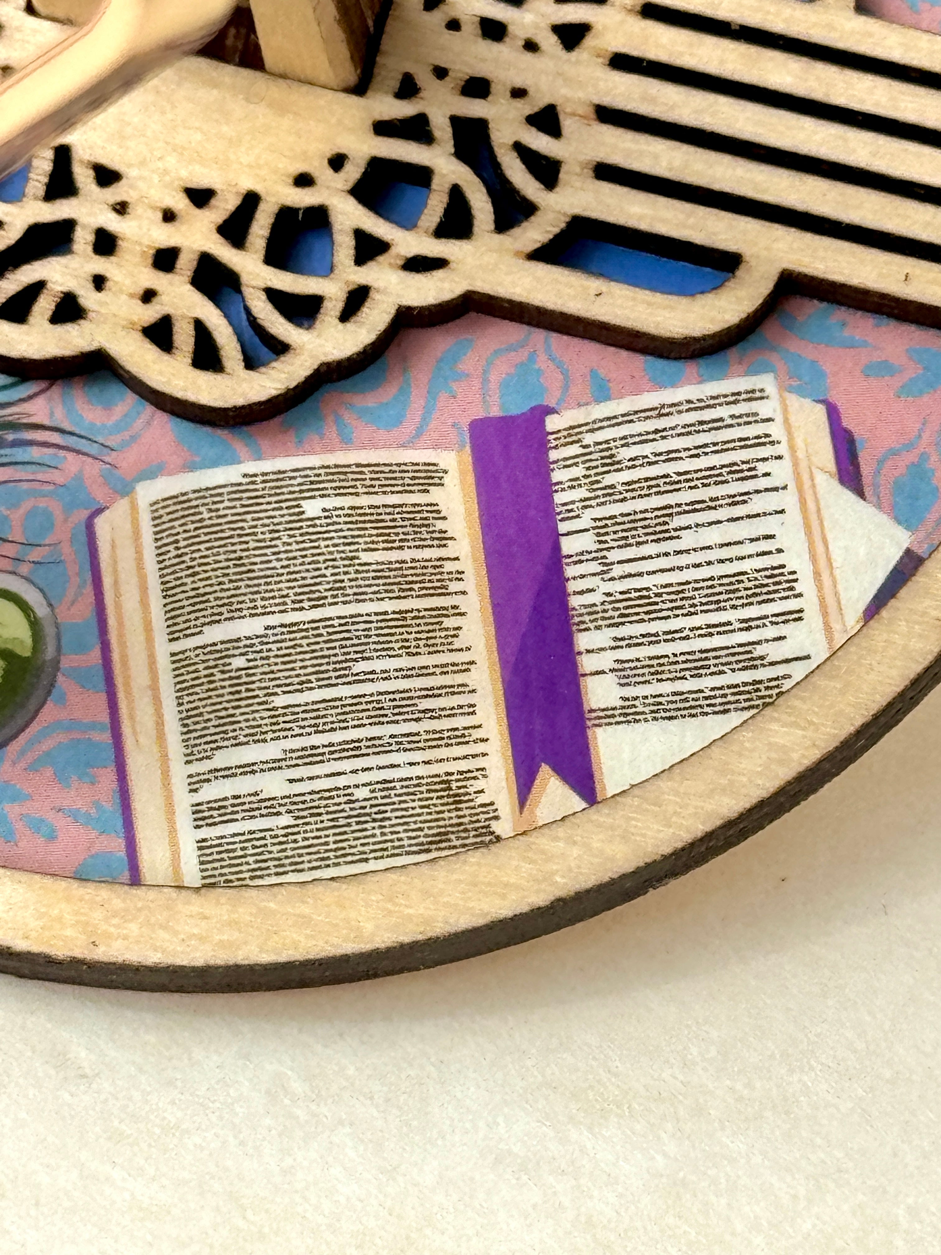 A detail image of the Mini Minder plate featuring an open book showing two pages from Pride & Prejudice.