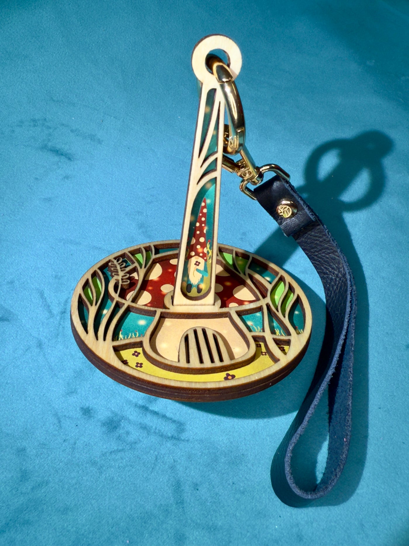 Decorative wrist yarn holder with artistic design on a blue background