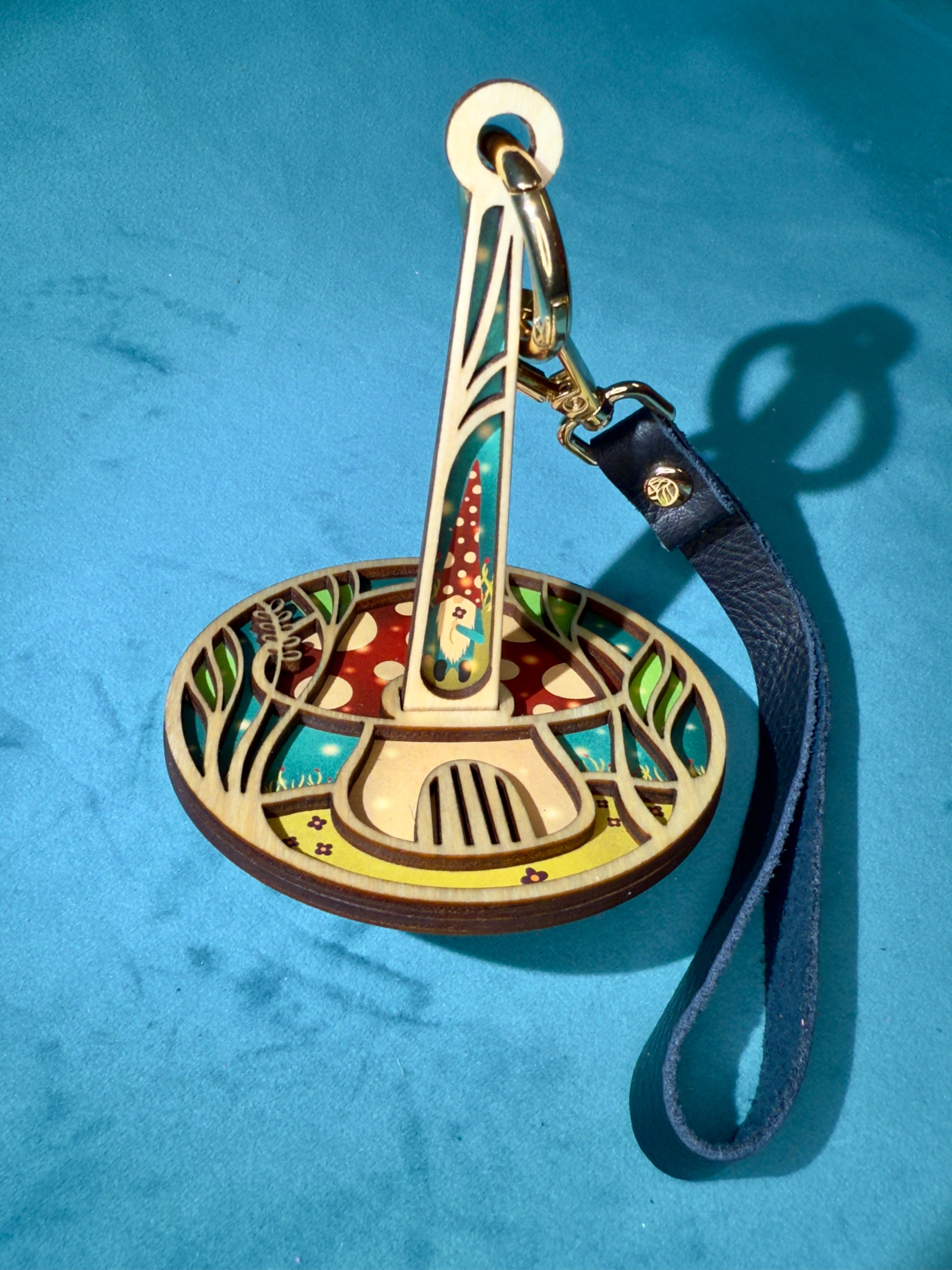 Decorative wrist yarn holder with artistic design on a blue background